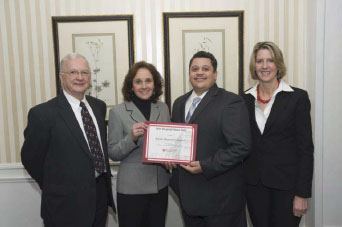 Alan Freeman, MD, (l) and Beth Roberts (r) from Harvard Pilgrim Health Care present Speare Memorial Hospital’s President & CEO Michelle McEwen and Director of Quality & Safety Kofi Cash the certificate of recognition for Speare being named to the 2010 Hospital Honor Roll.