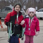 A pair of young volunteers helped hand out medals to all the runners and walkers at the finish line of Speare's Shamrock Shuffle 5K