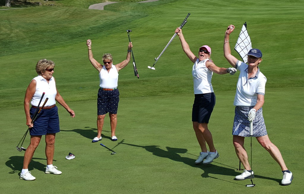 2015 Speare Golf Classic golfers celebrating a great putt