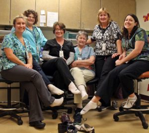 lab team members at Speare helping raise awareness for PAD by wearing one white sock