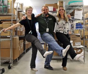 materials management team members at Speare helping raise awareness for PAD by wearing one white sock
