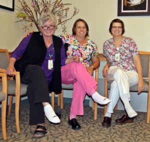 oncology team members at Speare helping raise awareness for PAD by wearing one white sock