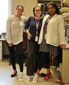 pharmacy team members at Speare helping raise awareness for PAD by wearing one white sock