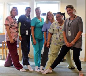 plymouth general surgery team members at Speare helping raise awareness for PAD by wearing one white sock