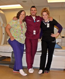 radiology ct scanner team members at Speare helping raise awareness for PAD by wearing one white sock