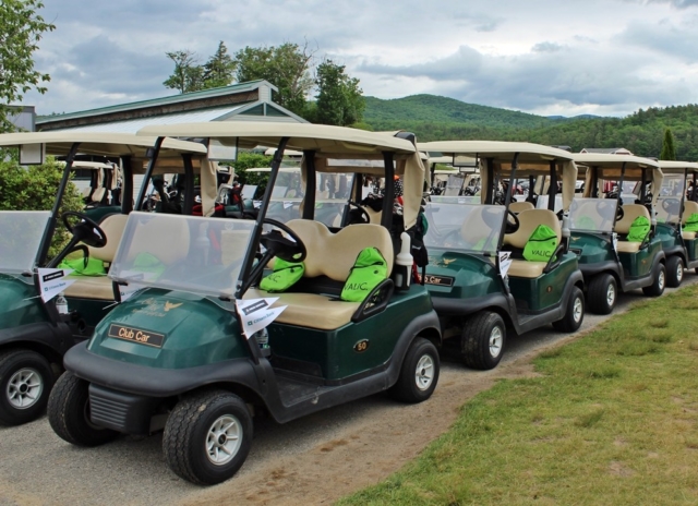 Golf Carts with Valic goodie bags and Granite State Plumbing & Heating and Academy Roofing cart flags