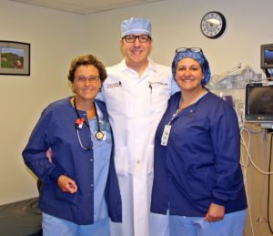 Joan Glidden RN preoperative nurse, Steve Ball MS MBA CRNA APRN director of anesthesiology, and Deborah Majersky RN intraoperative nurse.