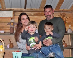 Angel and Jeffery Bray with sons, Harbor Bray (left) and Westley Bray (right) at their family farm stand.